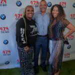A group of people are posing for a picture in front of a backdrop.