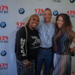 A group of people are posing for a picture in front of a wall.