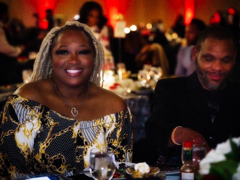 A woman and a man are sitting at a table at a dinner party.