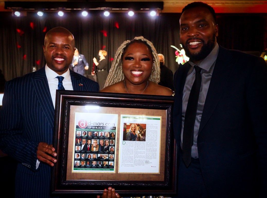 Two men and a woman are holding a framed picture.