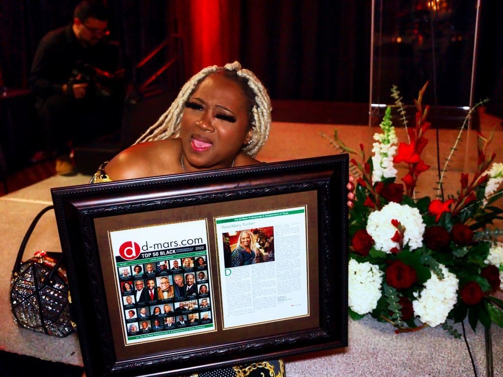 A woman is sitting in front of a framed picture that says chicago