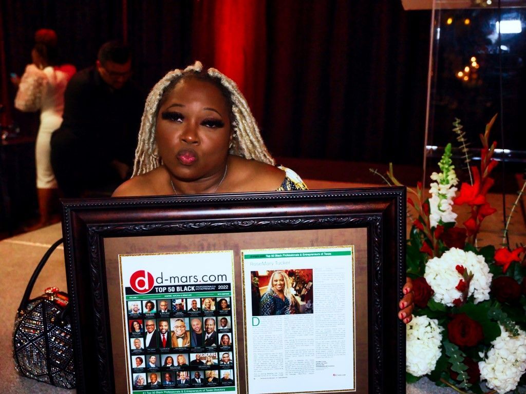 A woman is holding a framed chicago magazine