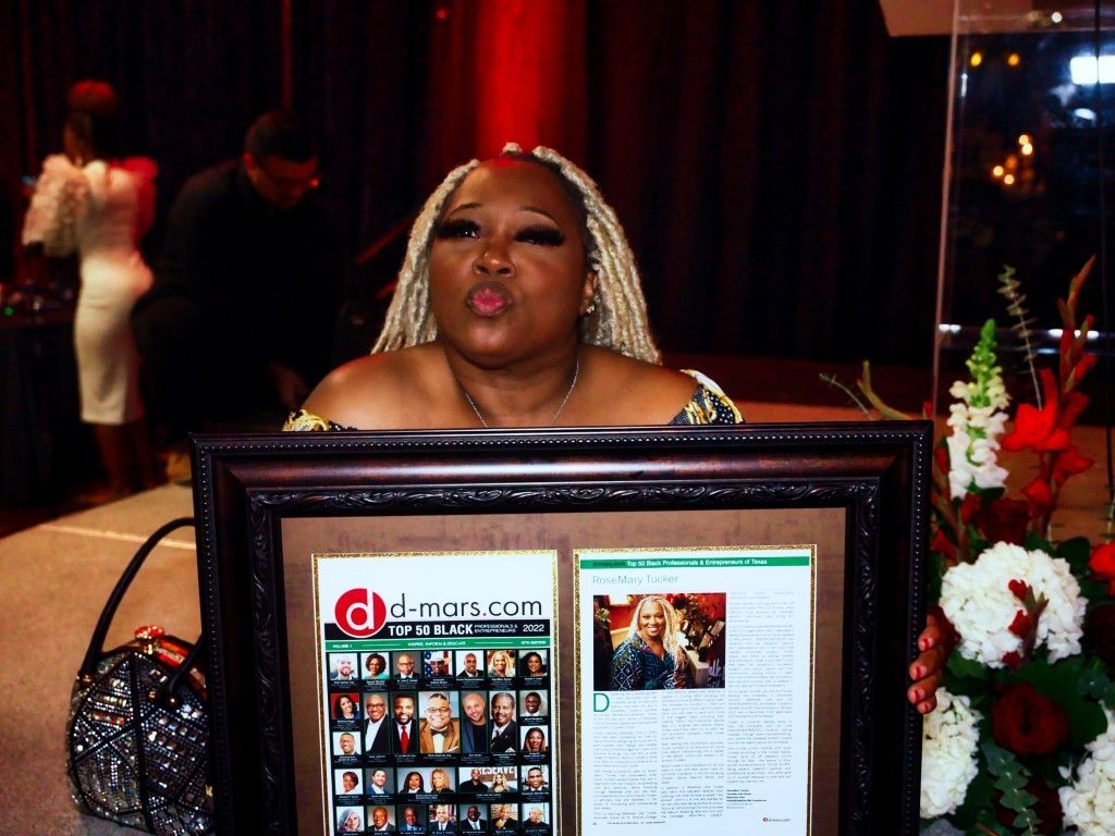 A woman is holding a framed magazine that says djmag.com