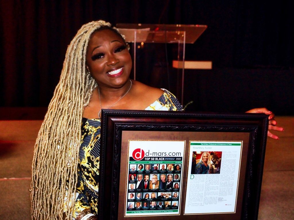 A woman with long blonde braids is holding a framed picture