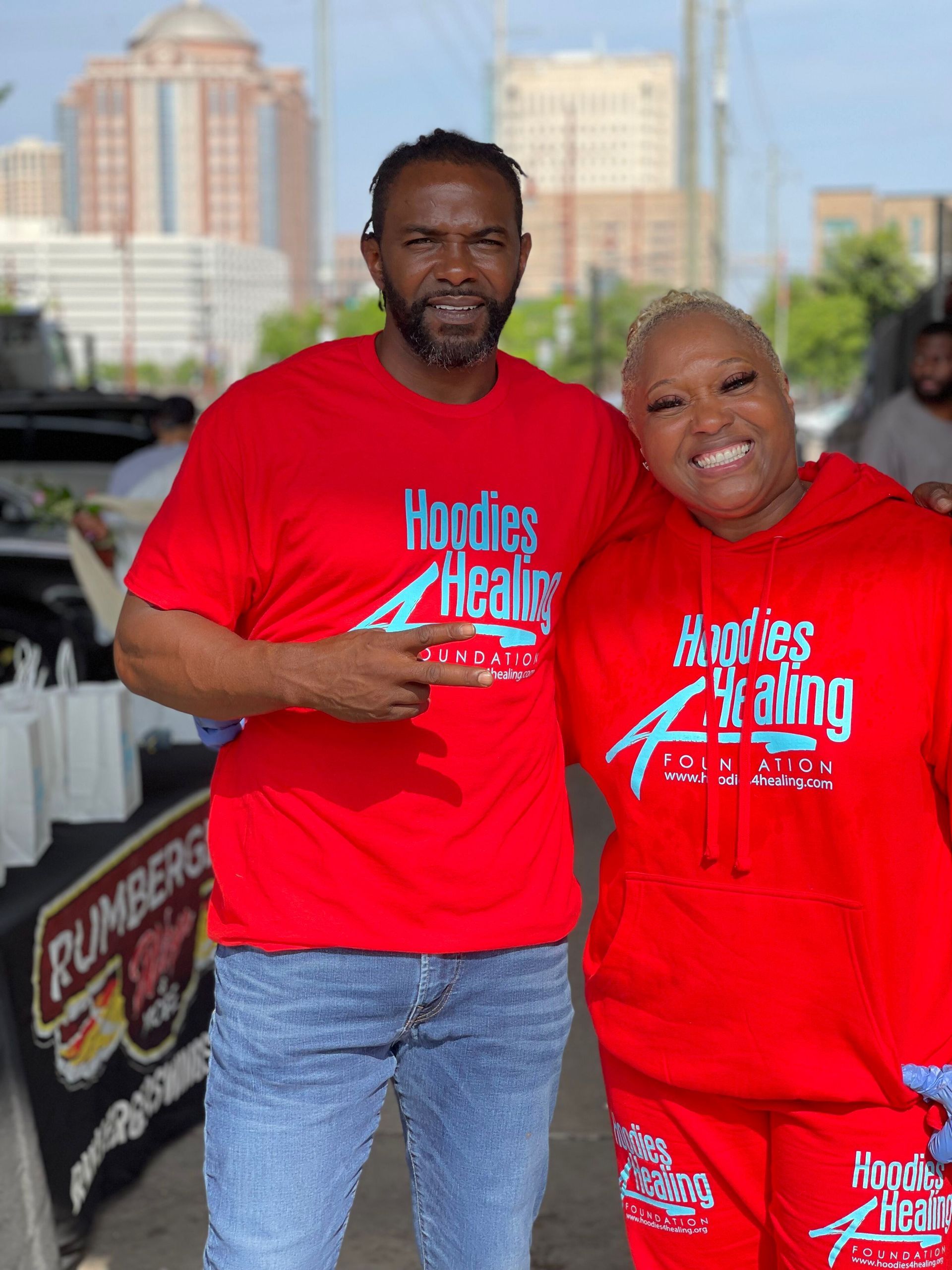 A man and a woman wearing red shirts are posing for a picture.