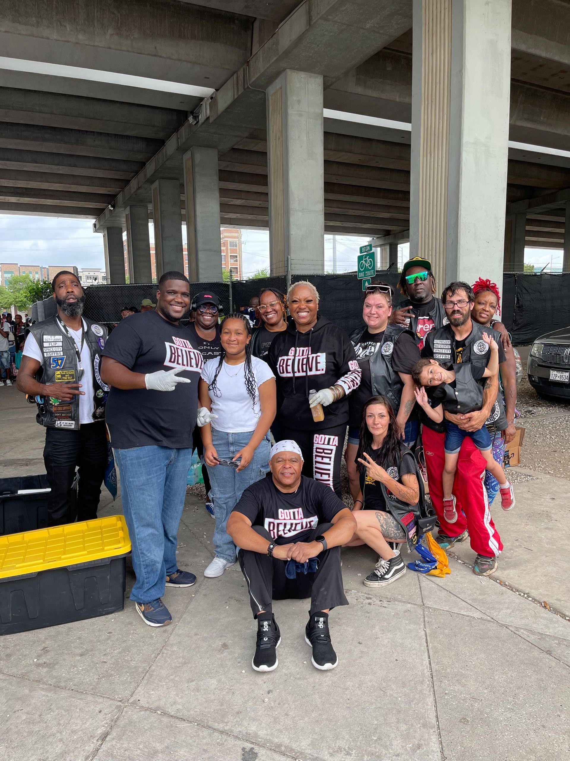 A group of people are posing for a picture in front of a building.