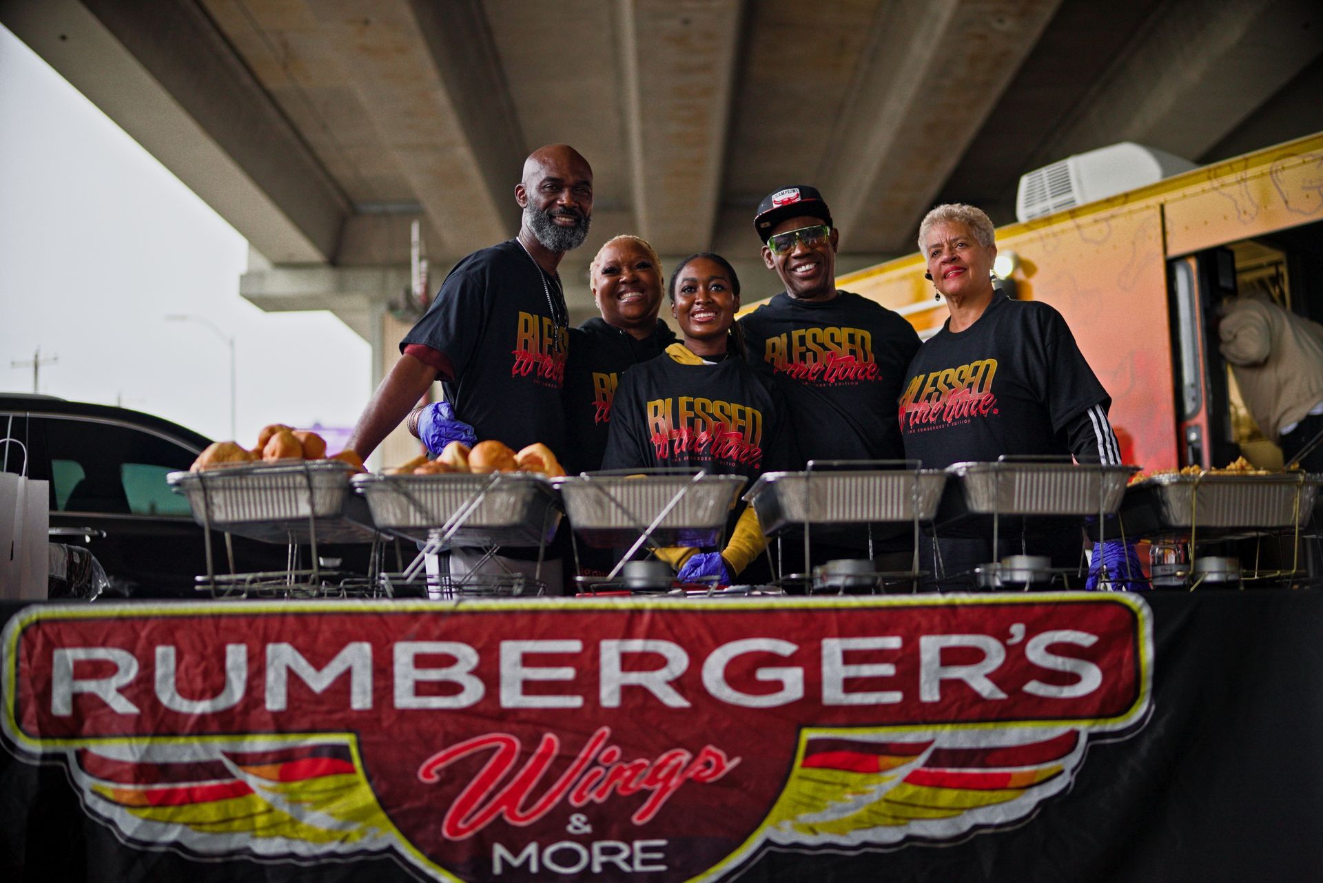 A group of people are standing in front of a food truck.