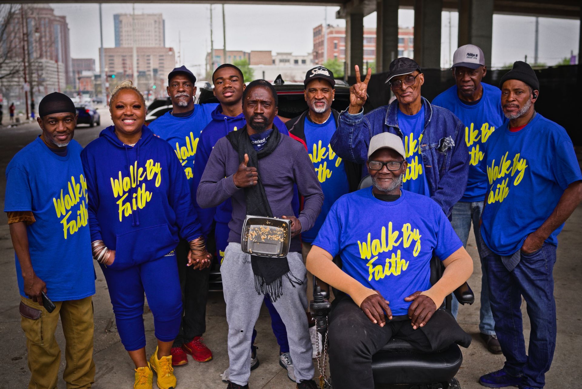 A group of people wearing blue shirts that say walk by faith