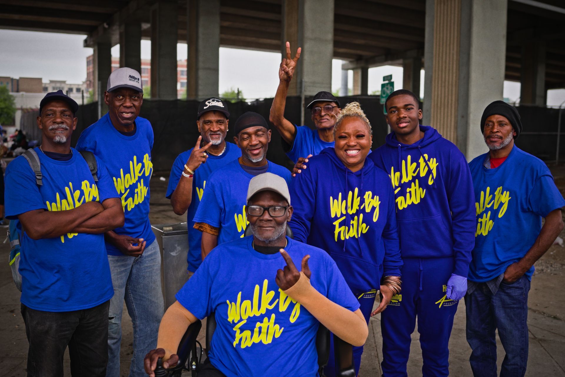 A group of people wearing blue shirts that say walk by faith