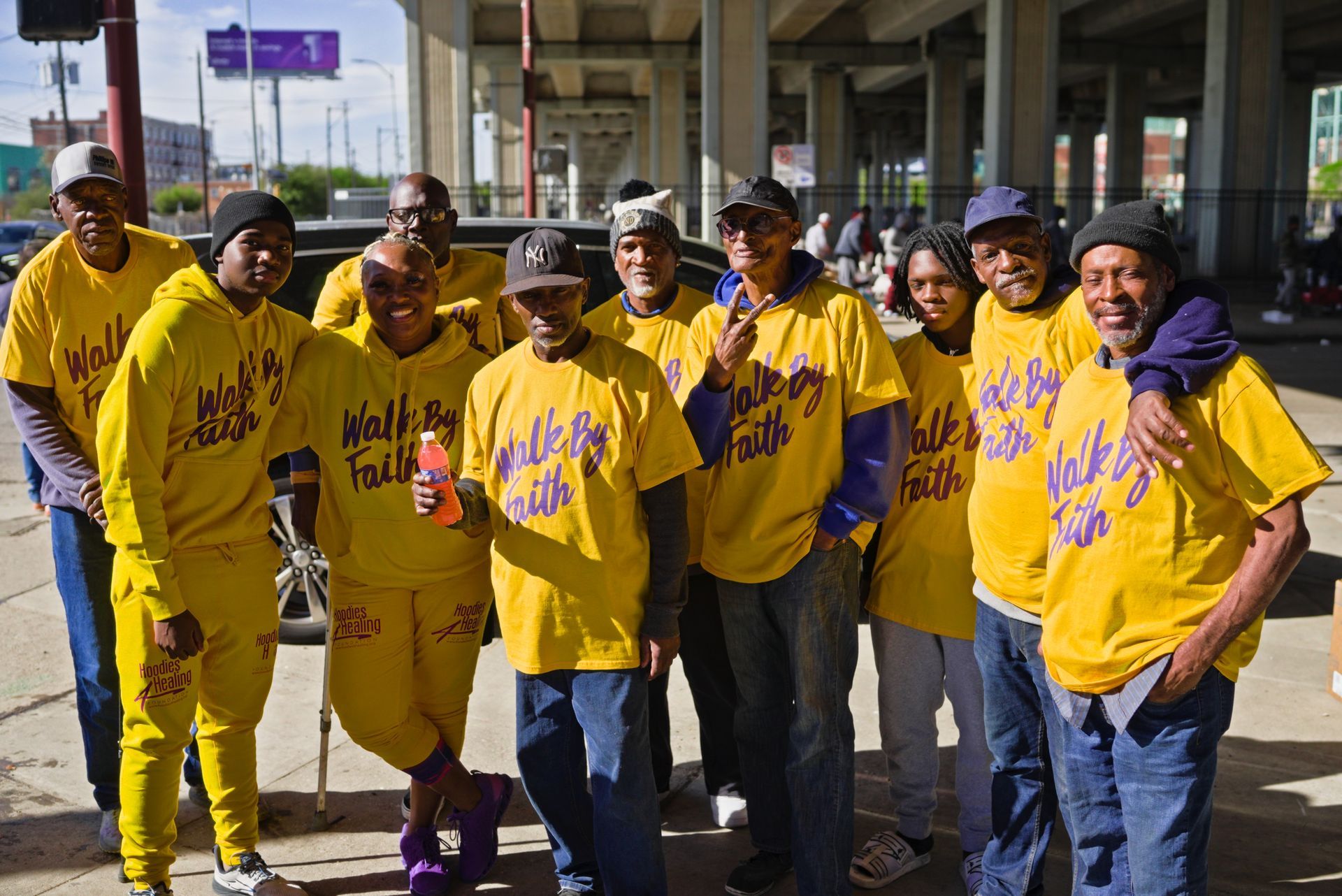 A group of people wearing yellow shirts that say walk by faith