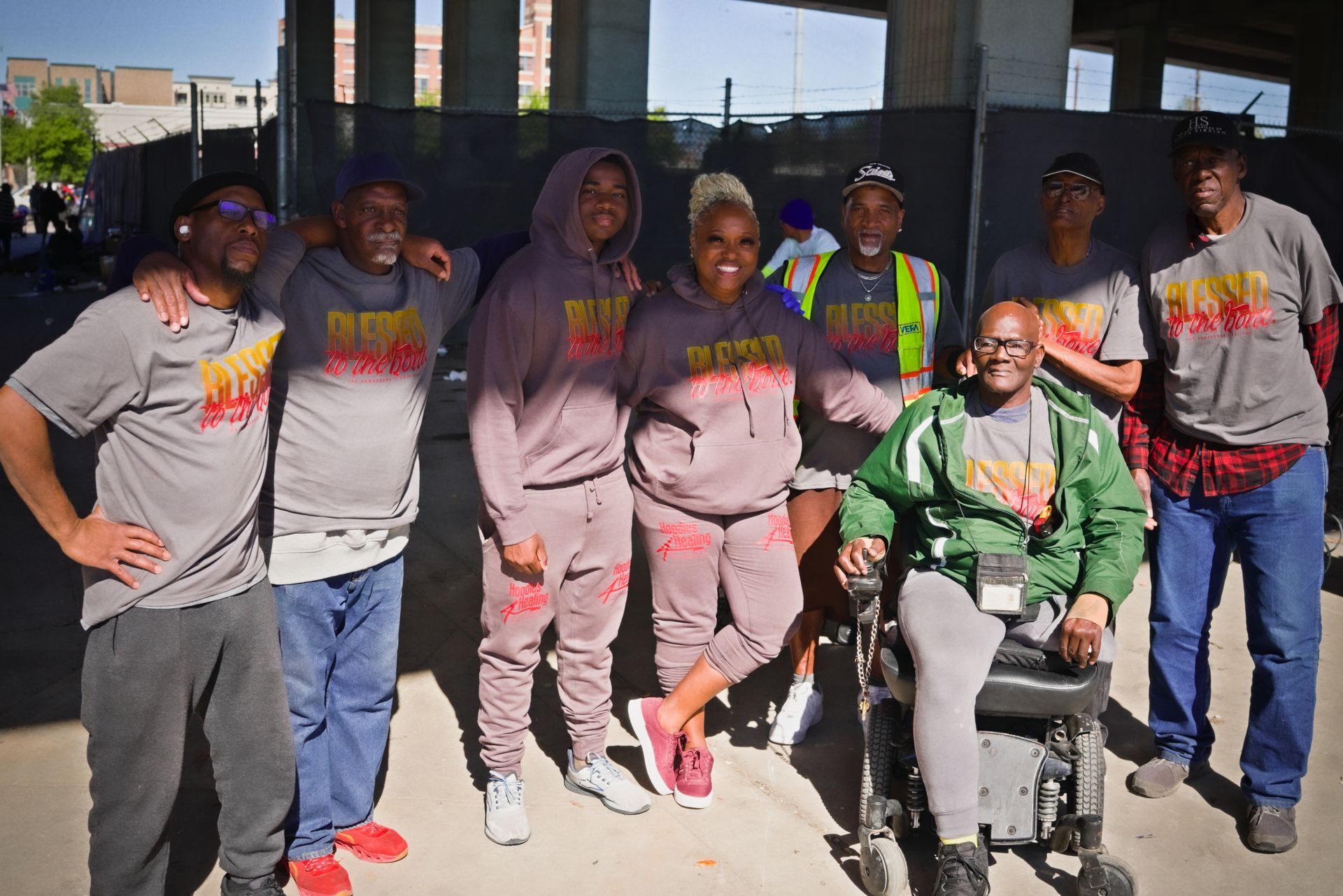 A group of people posing for a picture including a man in a wheelchair