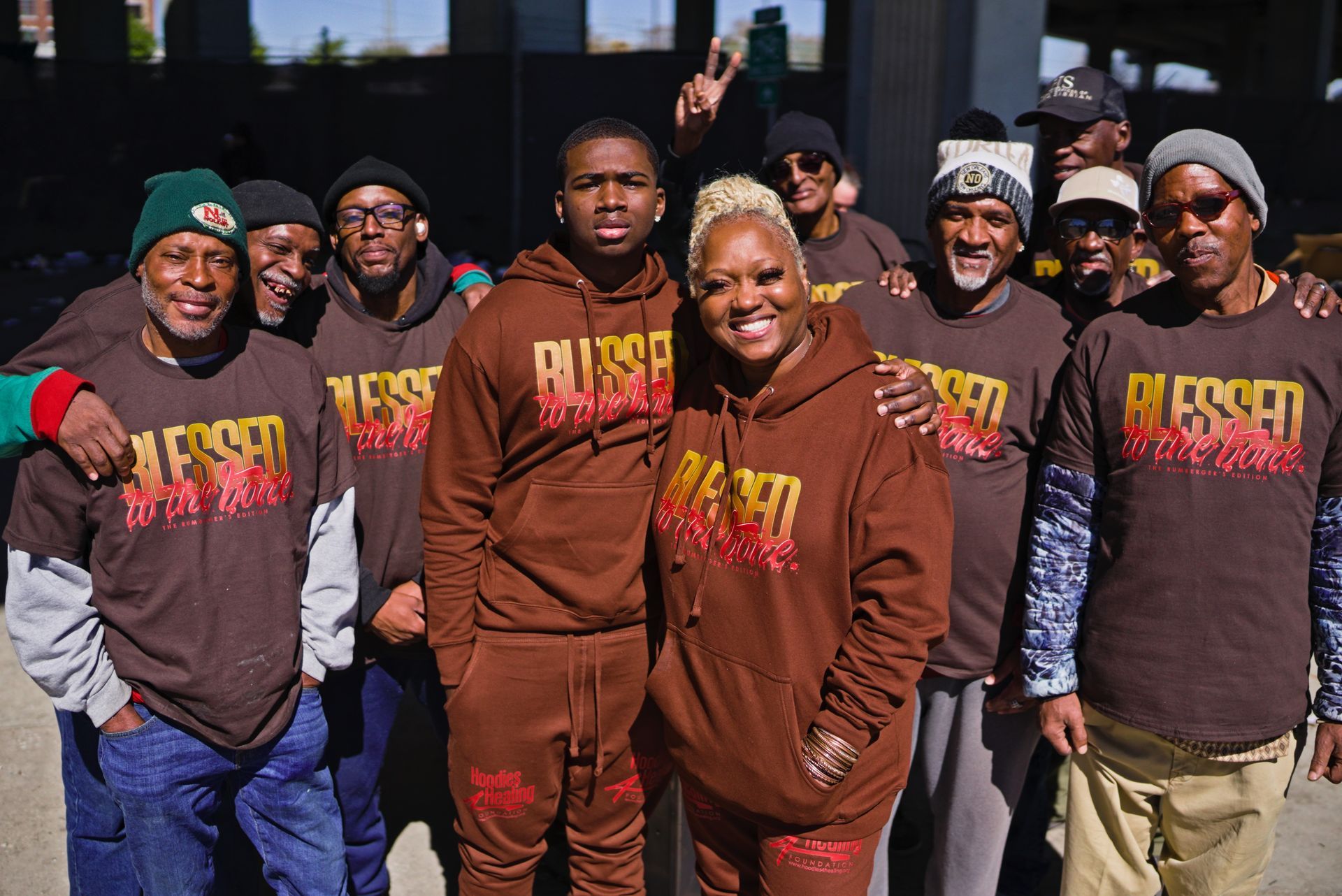 A group of people wearing brown shirts with the word blessed on them