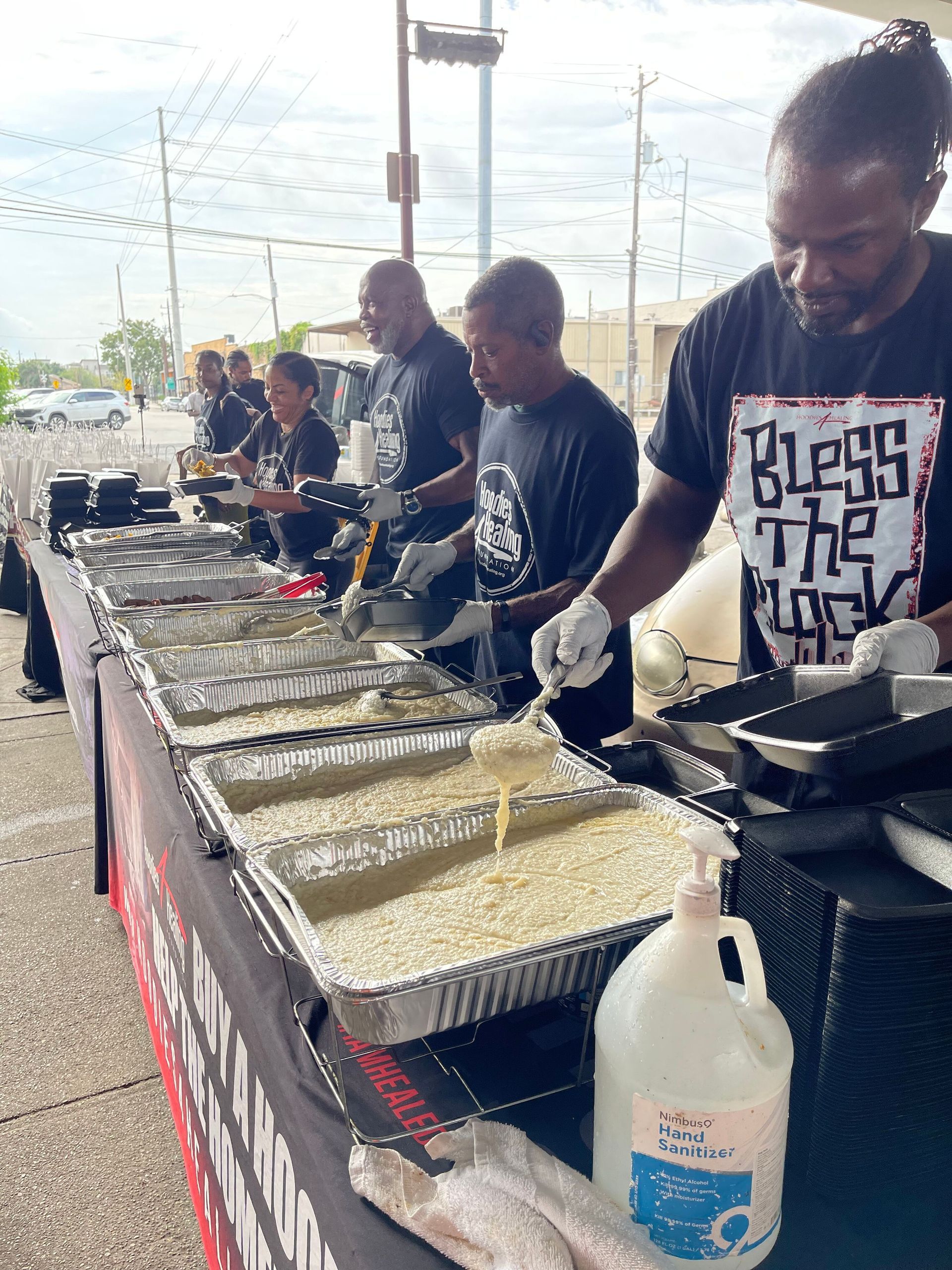 A group of people are preparing food at a table.