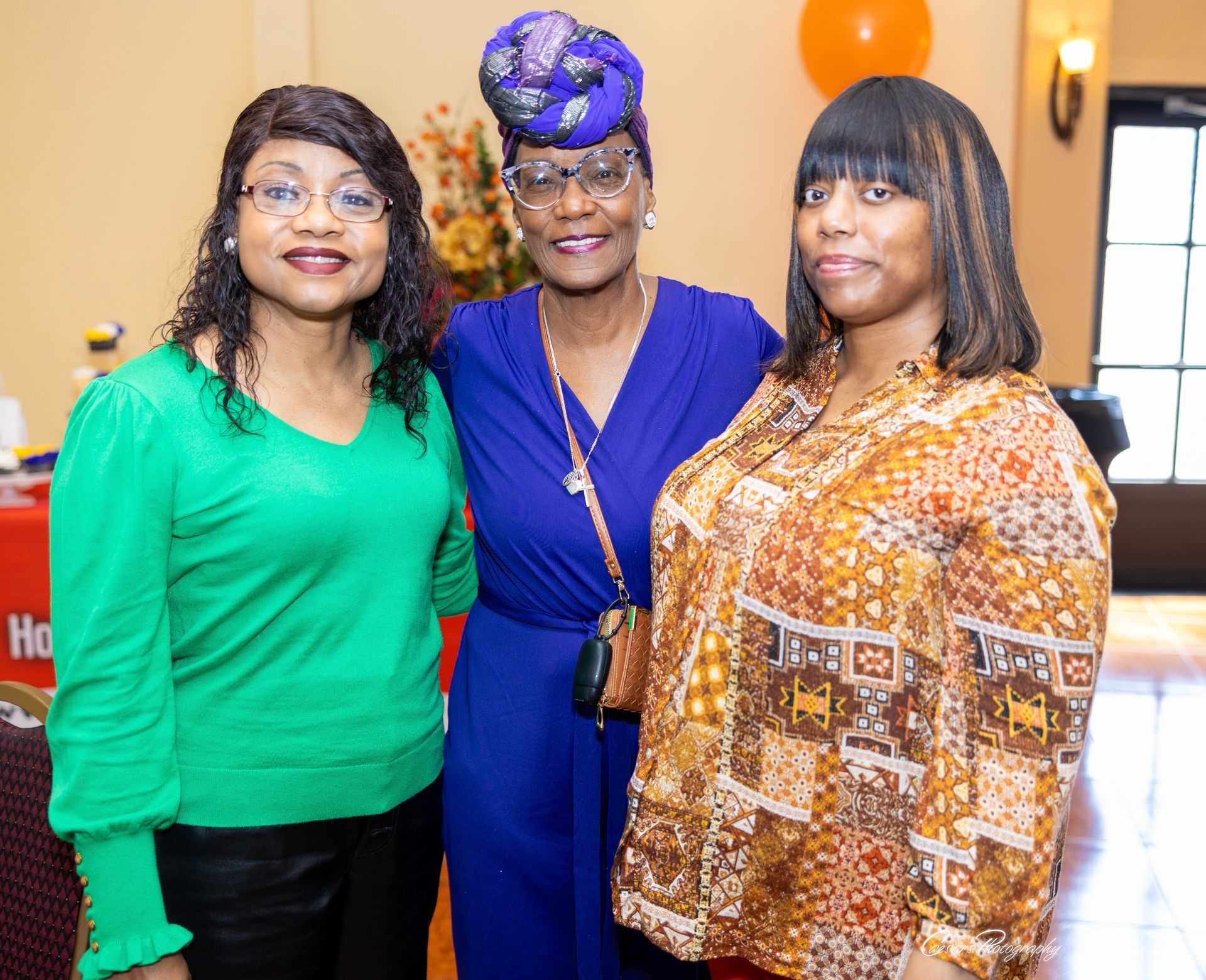 Three women are posing for a picture together in a room.