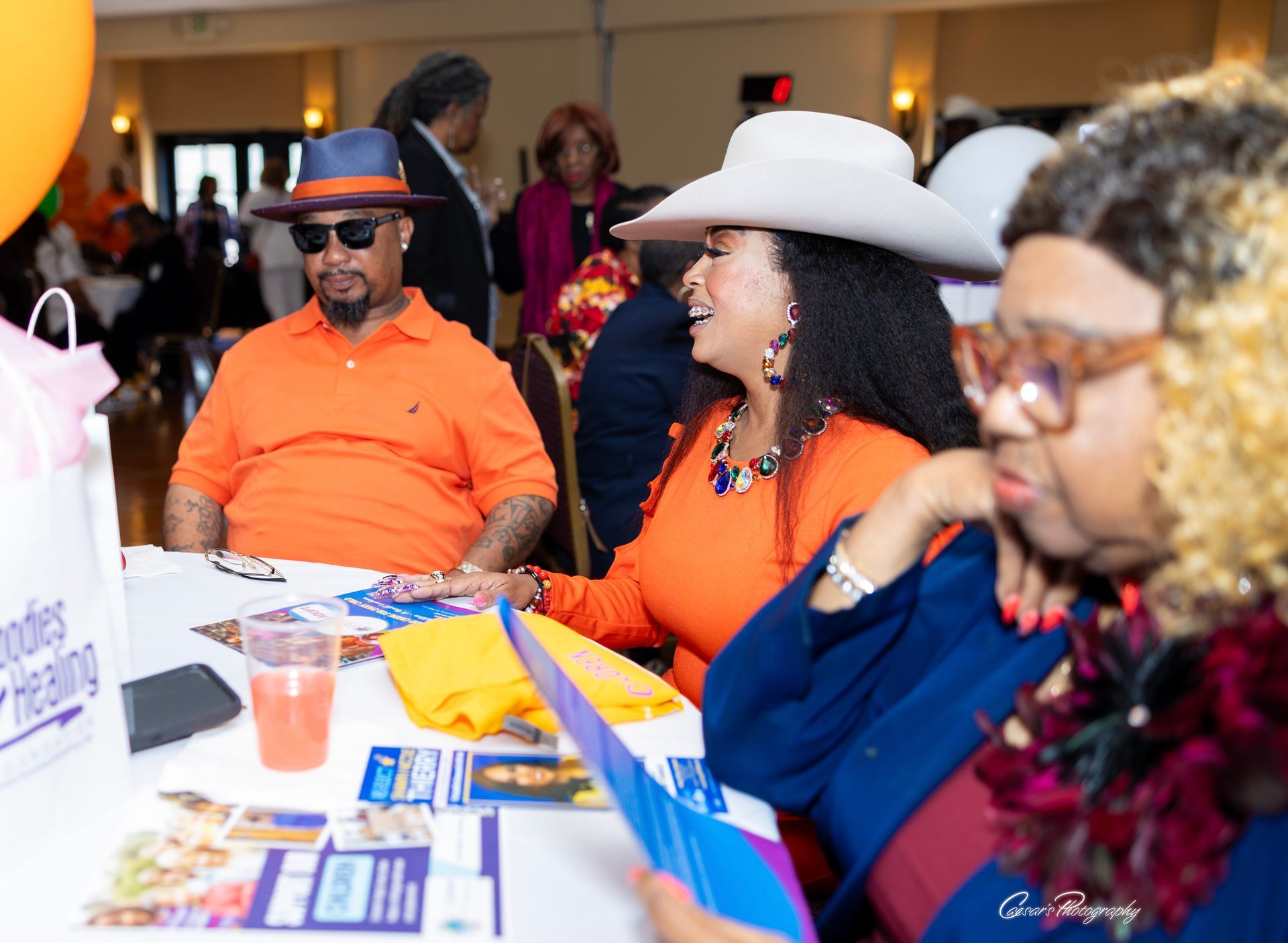 A group of people are sitting at a table in a room.