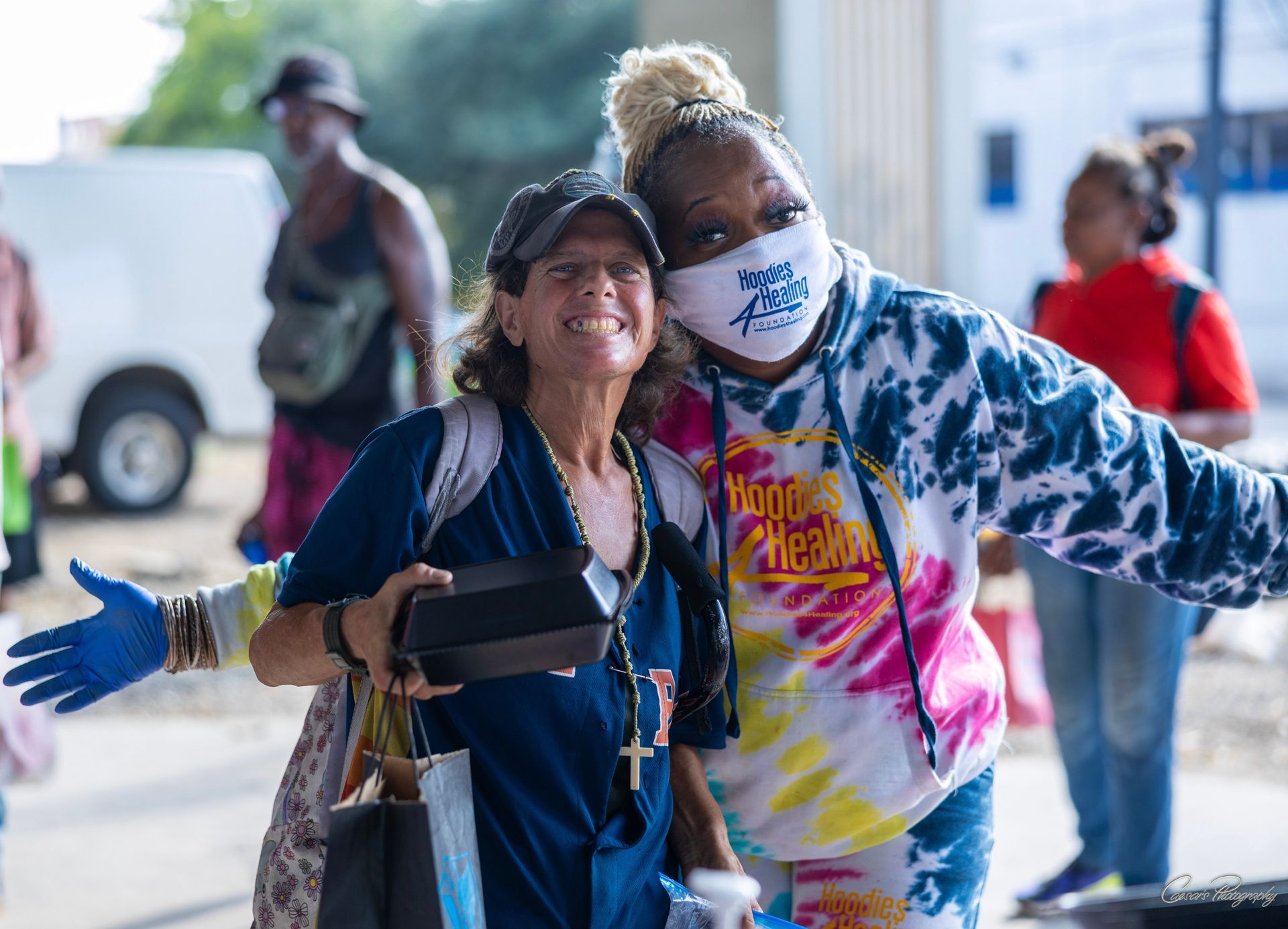 Two women wearing face masks are posing for a picture.