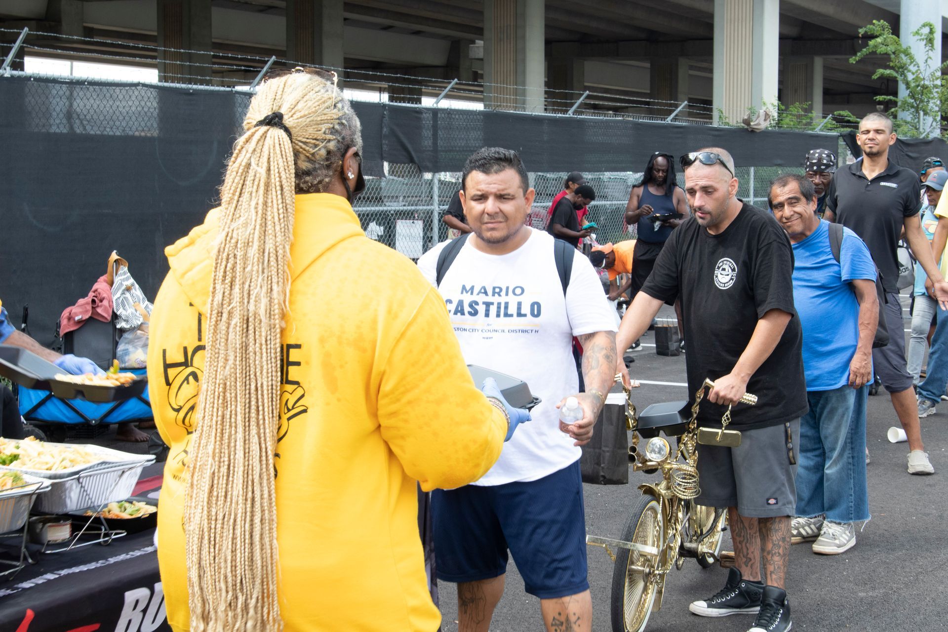 A man in a mario castillo shirt is talking to a man in a yellow robe.