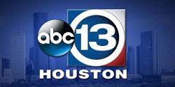 A logo for abc 13 houston with a city skyline in the background.