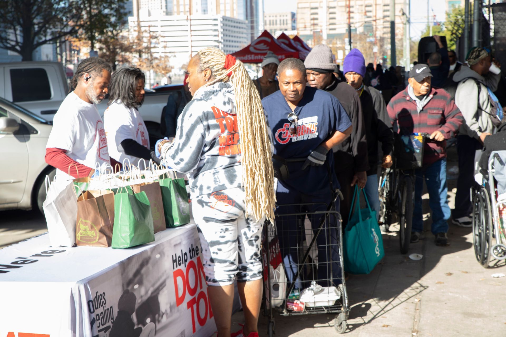A group of people are standing around a table.