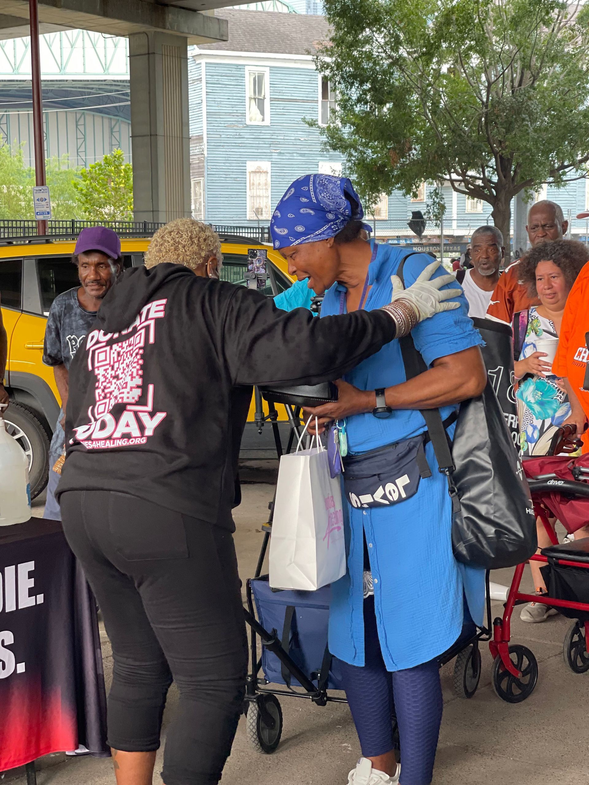 A woman wearing a black hoodie that says 1 day on it