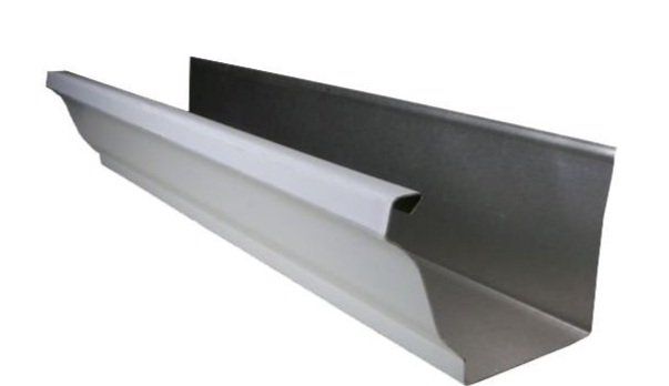 A white gutter is sitting on a white surface.