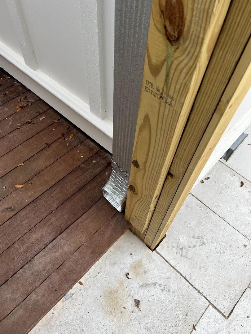 A wooden door with a drain pipe attached to it.