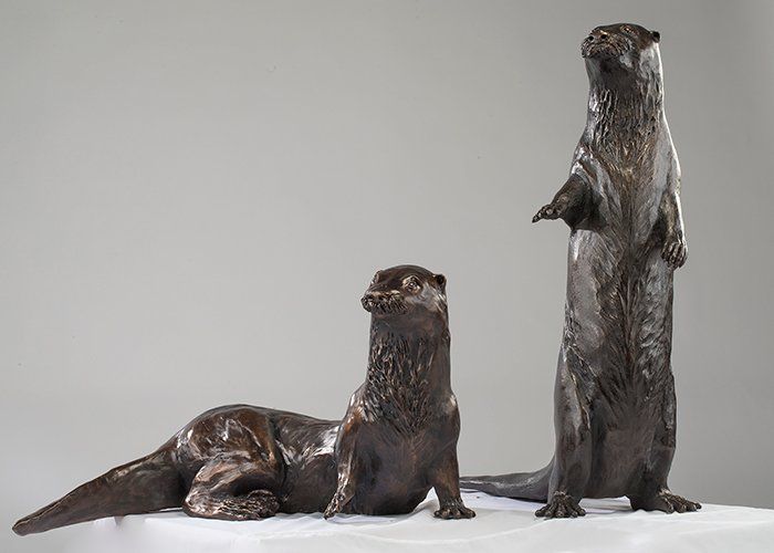 otter pair bronze sculptures