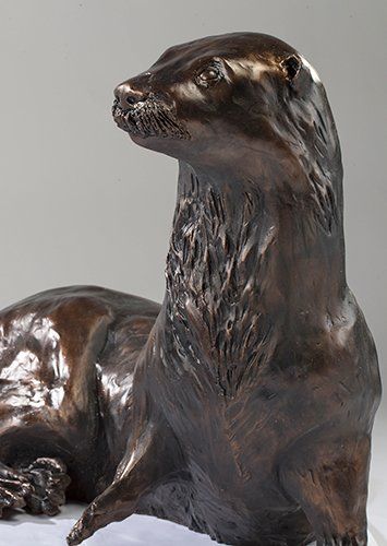 bronze sculpture of resting otter