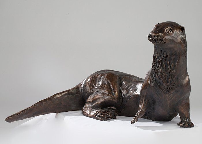 otter resting in bronze