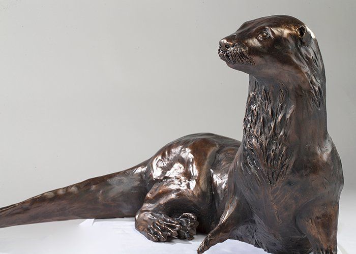 bronze sculpture of resting otter close up