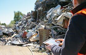 Man checking dumped metals — Metal Recycling in Cleveland, OH