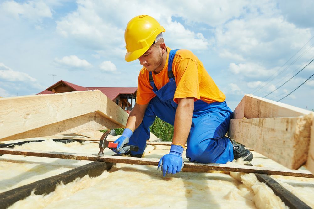 Construction Roofer Carpenter Worker Hammering Wood Board — Roof Trusses in Landsborough, QLD