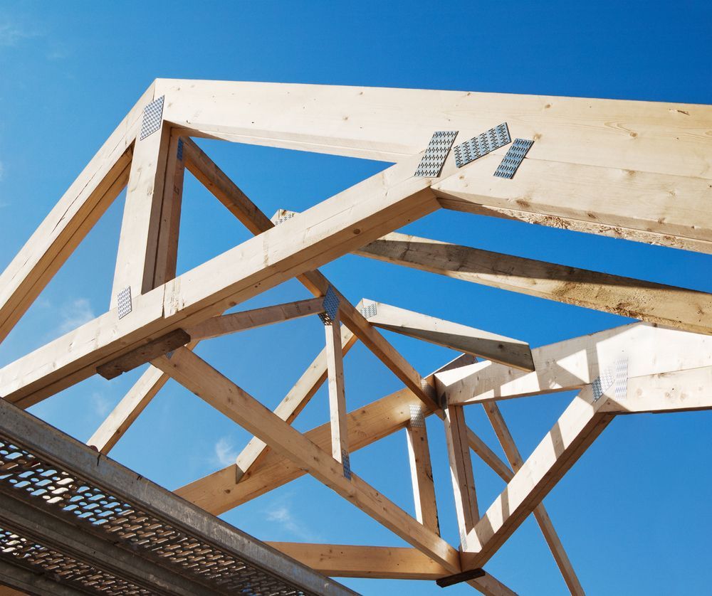 Wooden Rafters Against the Blue Sky — Roof Trusses in Gympie, QLD