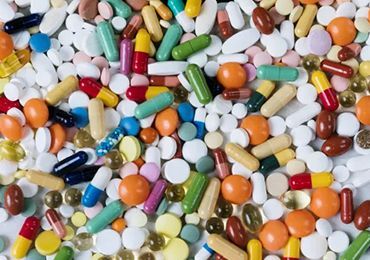 A pile of colorful pills and capsules on a table