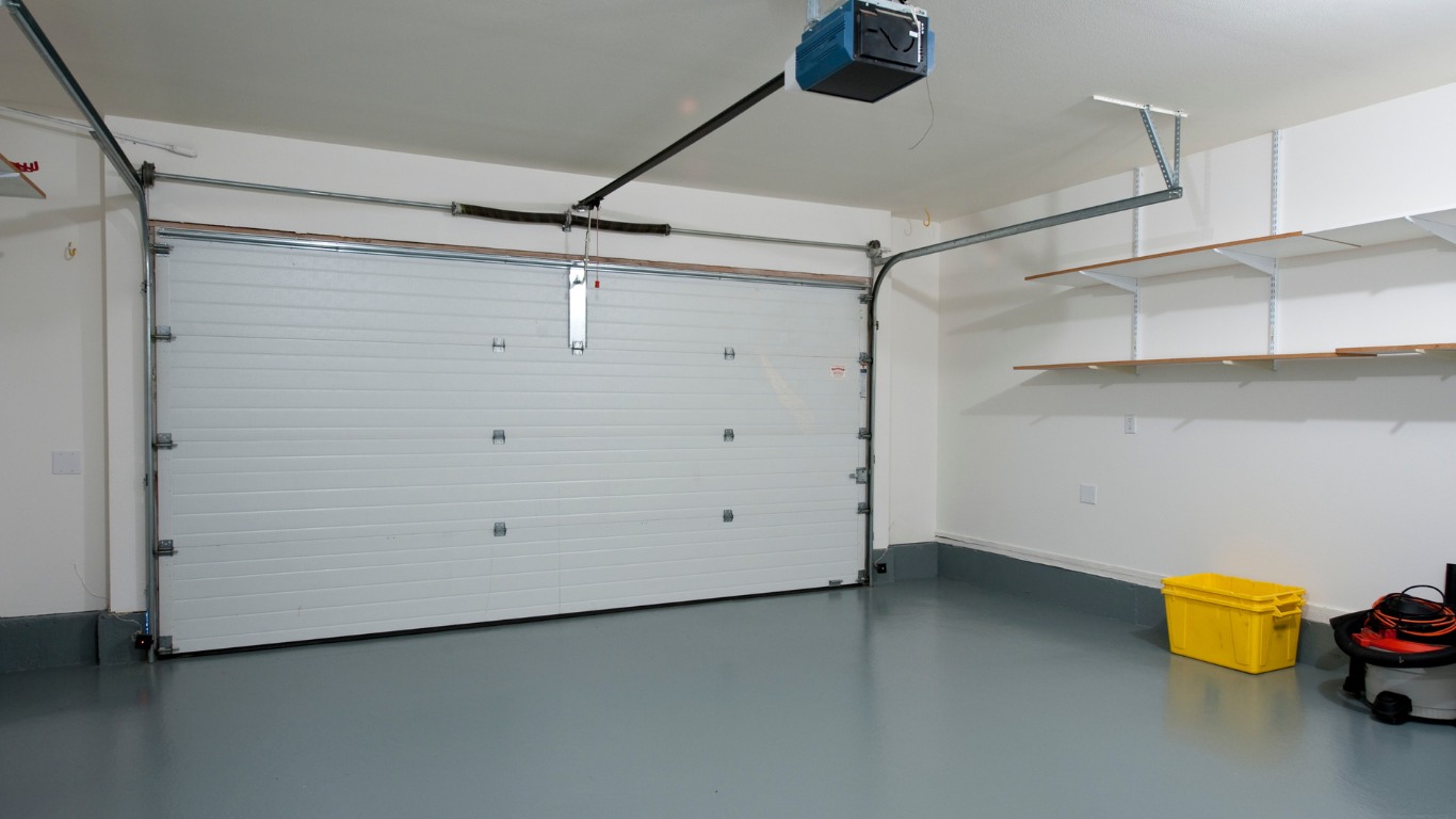 a green metal garage with a white door and a covered porch .