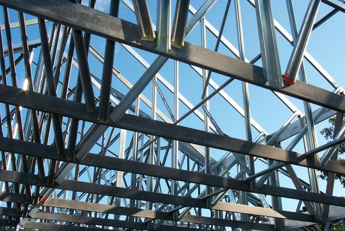 a large metal building with a blue sky in the background .