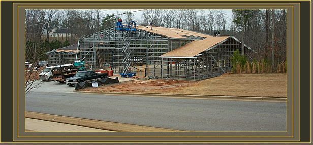 a picture of a house under construction with a truck parked in front of it .