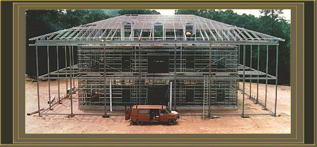a red van is parked in front of a building under construction