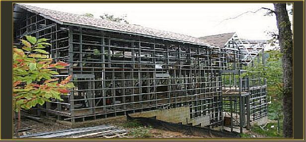 a house is being built with a lot of metal frames .