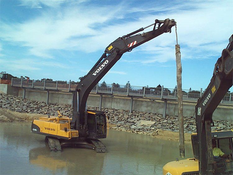 Yellow and Black Excavator Working in the Water — Victor Harbor, SA — South Coast Sand & Civil