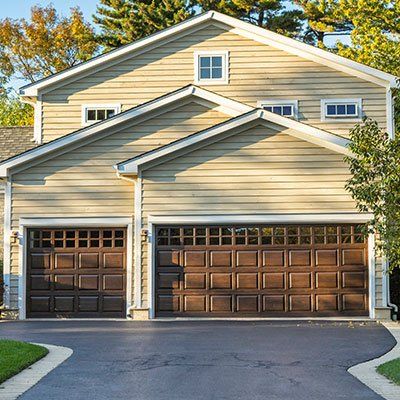 Garage Doors — Traditional American Home With Garage Wood Door in Springfield, IL