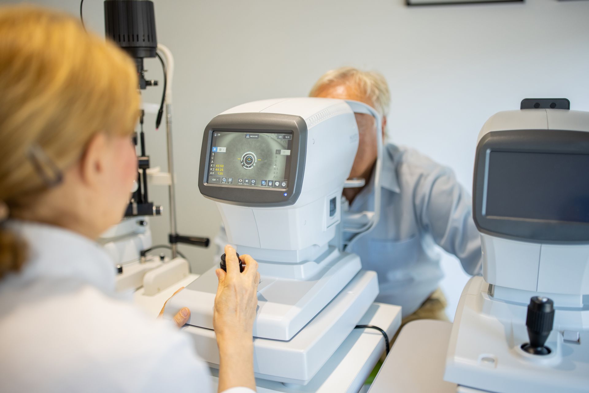 A man is getting his eyes checked by an ophthalmologist.