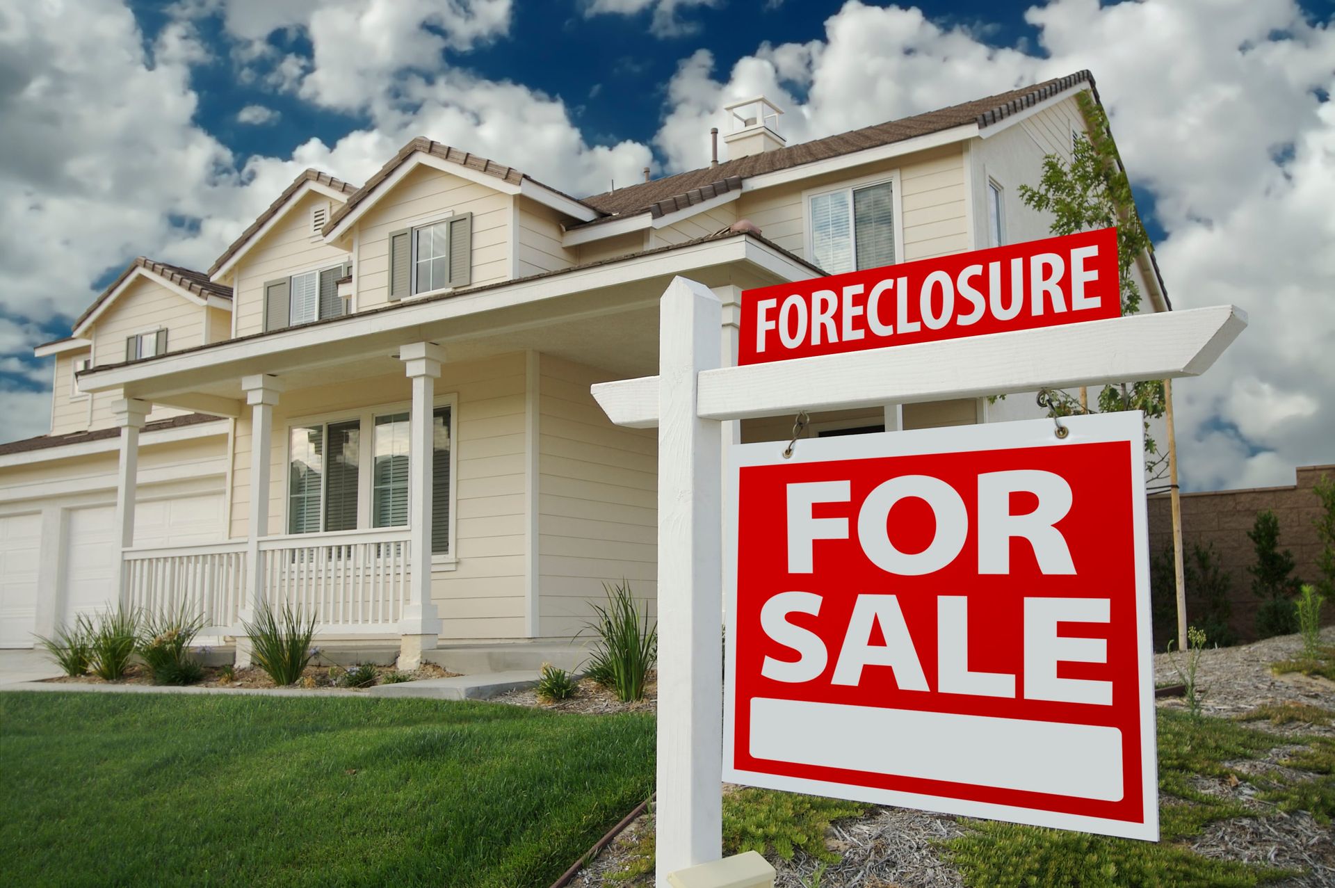 A house with a for sale sign in front of it