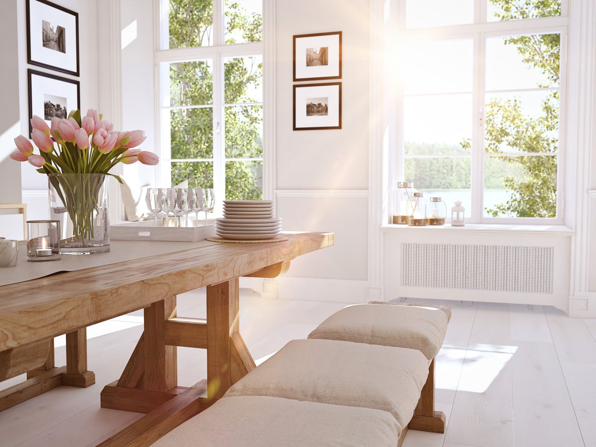A dining room with a wooden table and benches and a vase of flowers.