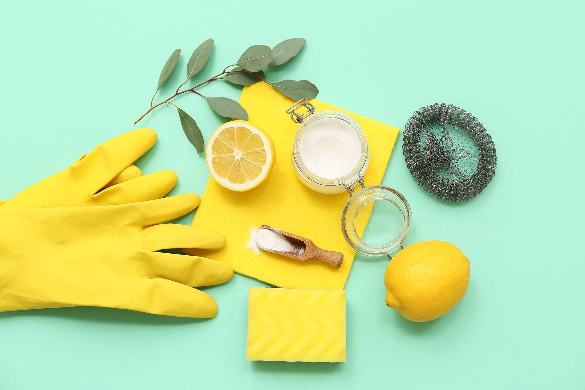 A person wearing yellow rubber gloves is cleaning with lemons , salt , and soap.