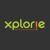 Logo for Xplorie featuring lime green text on a dark gray background with an orange exclamation point as the letter 'i'.