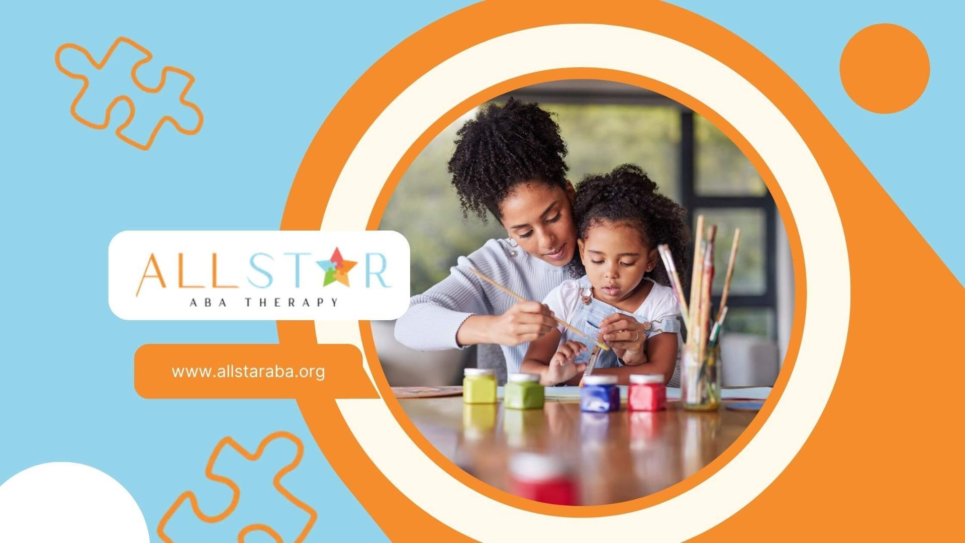 ABA therapist helping child with autism paint with a paintbrush at a wooden table during ABA therapy