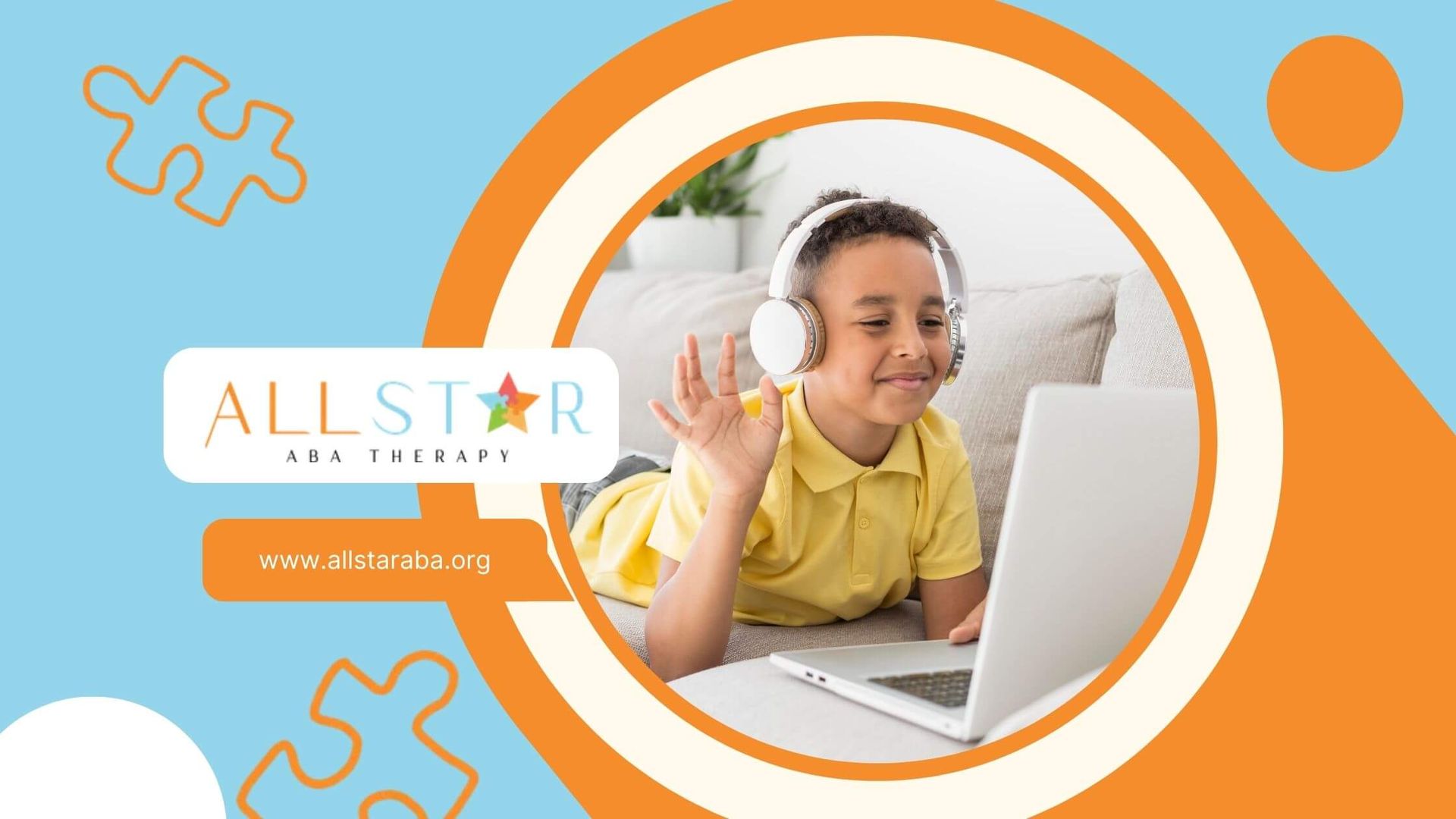 Autistic boy with headphones smiling and waving at a laptop screen during an online video call.