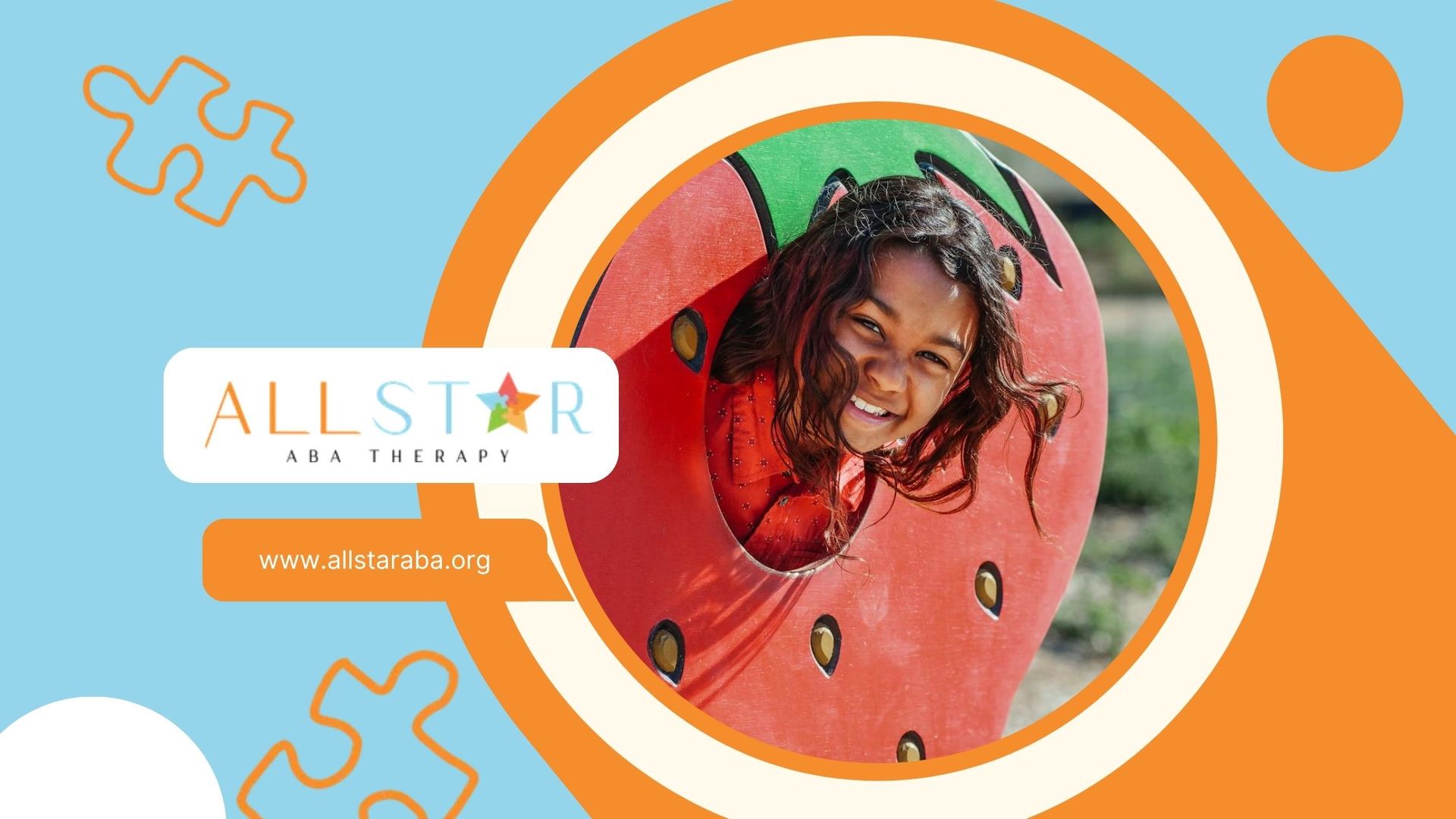 Autistic child smiling through a colorful strawberry-shaped play structure during ABA therapy in MD.