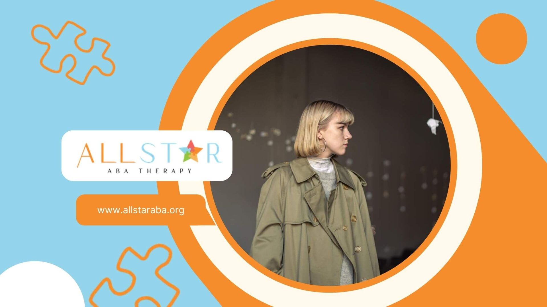 Woman with autism in a trench coat looking right, indoors with hanging paper decorations.